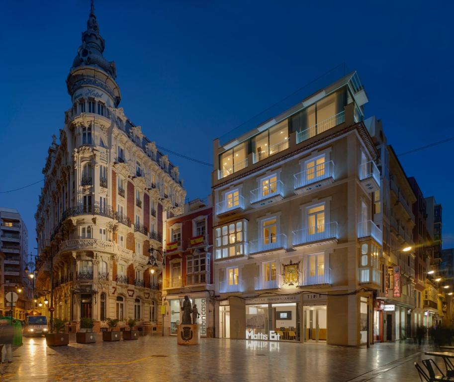 a couple of buildings in a city at night at San Sebastian Suites in Cartagena