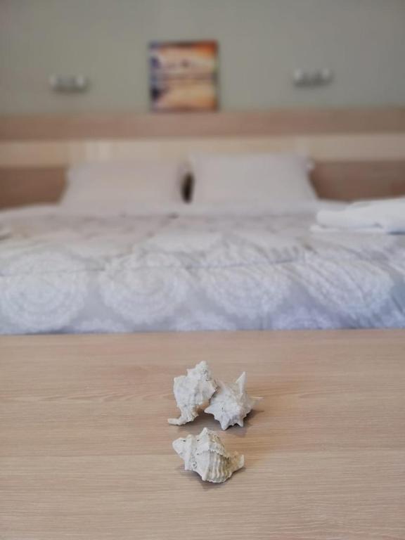 a piece of paper sitting on a table next to a bed at Aloni Studios and Apartments in Lassi