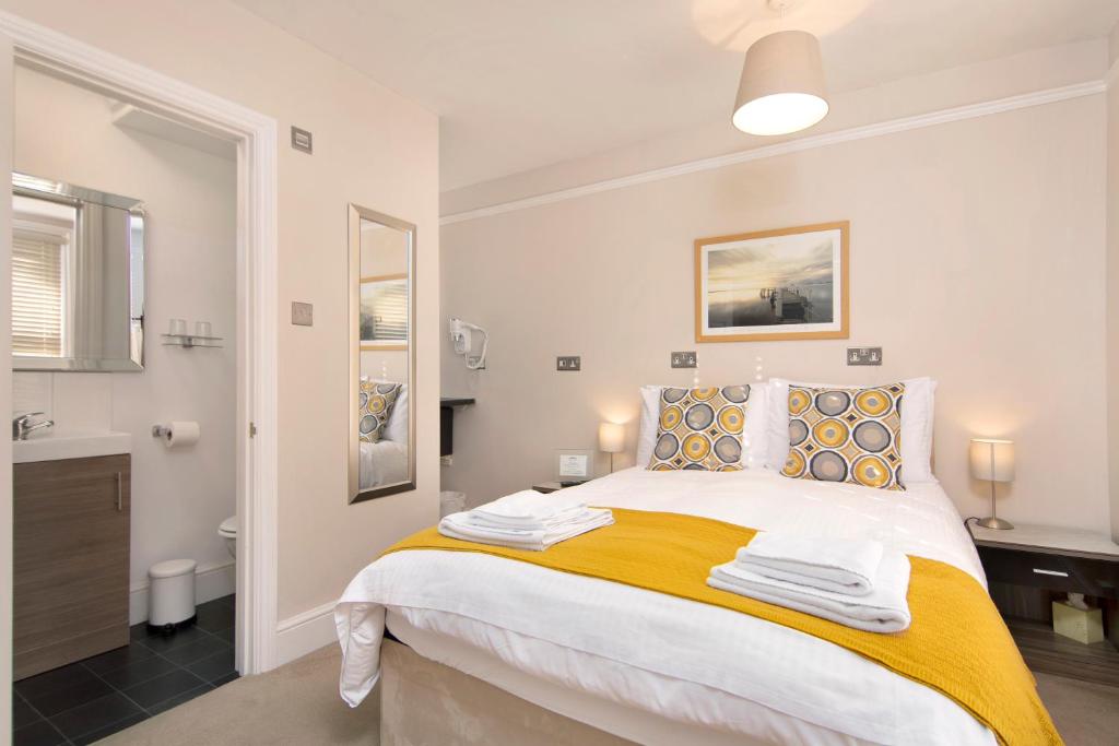a bedroom with a large bed and a bathroom at Redhouse in Salisbury