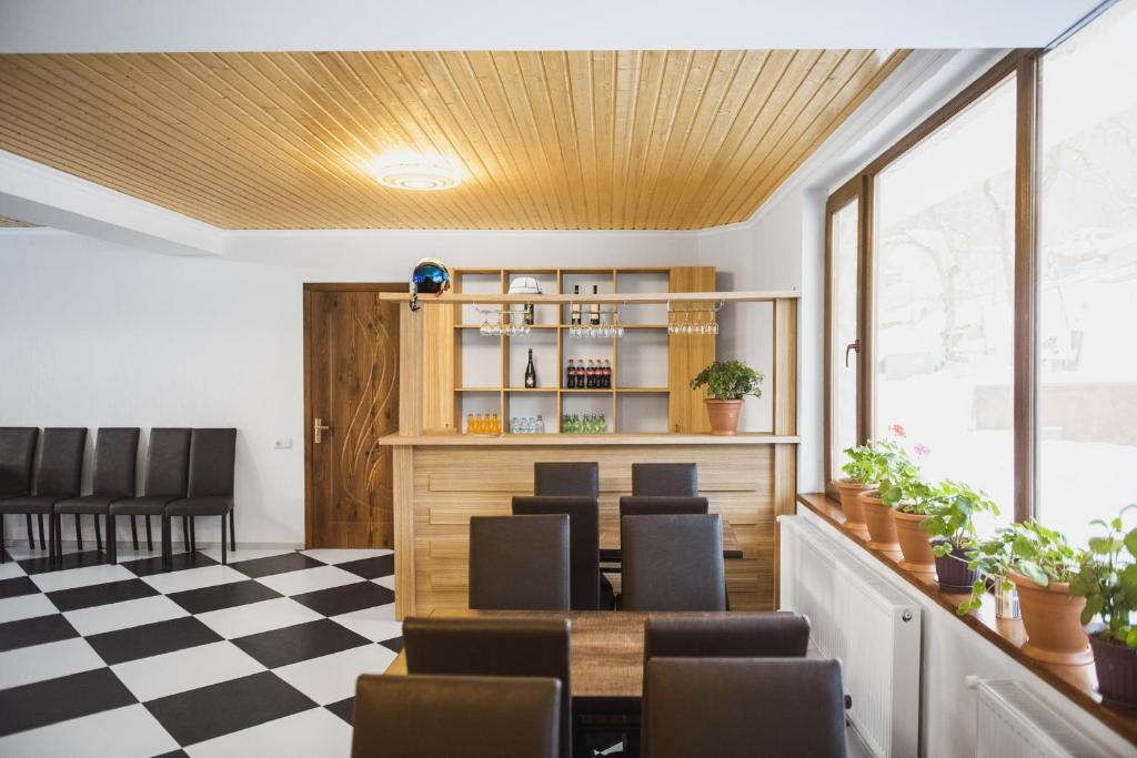 a dining room with a checkered floor at Hotel panorama svaneti in Mestia