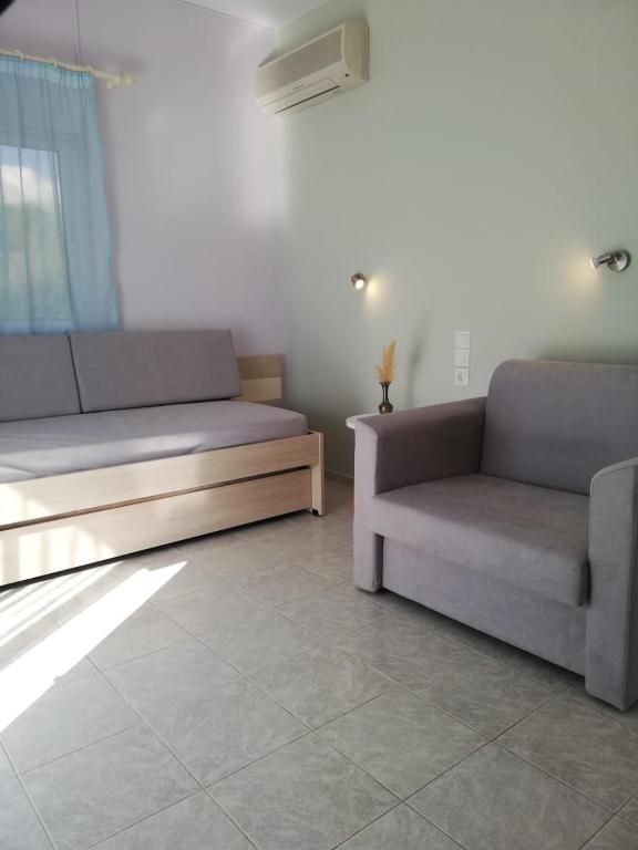 a living room with two couches and a couch at Aloni Studios and Apartments in Lassi
