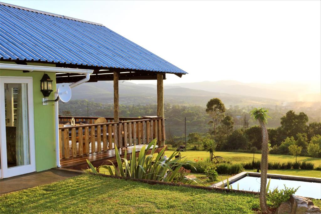 a house with a solar roof with a view at Round Here Self-Catering Holiday Home in Sabie