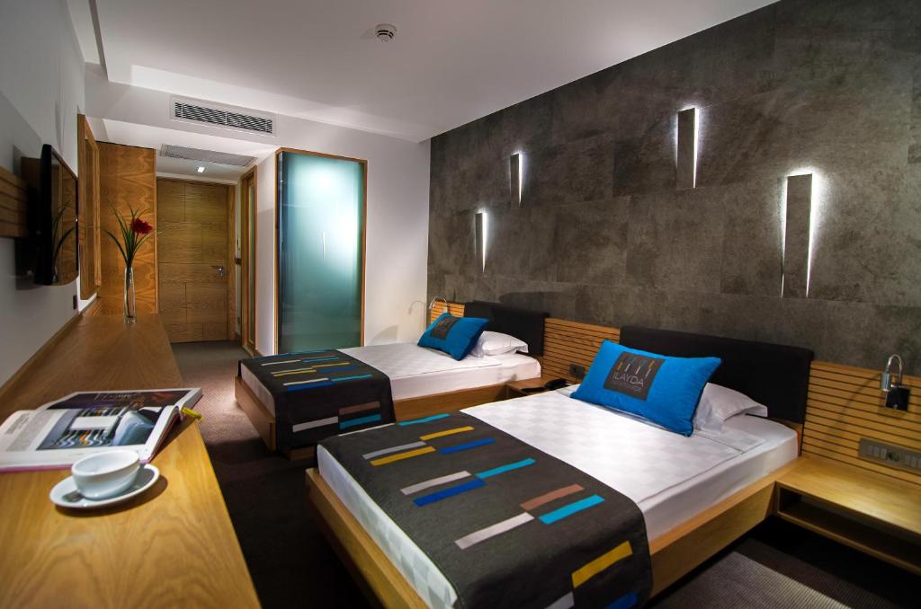 A bed or beds in a room at Ilayda Avantgarde Hotel