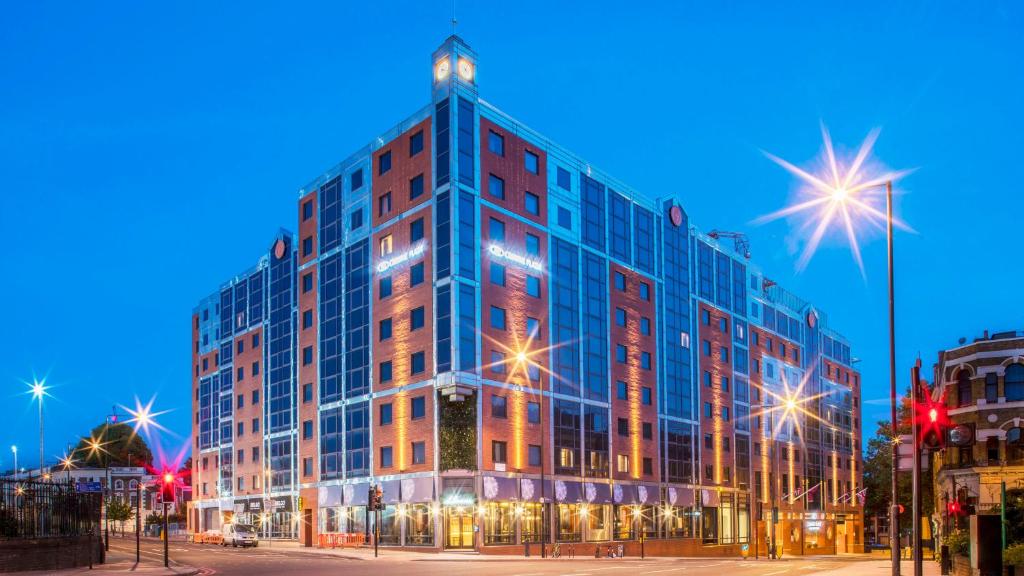 duży szklany budynek z oświetleniem na górze w obiekcie Crowne Plaza London Kings Cross, an IHG Hotel w Londynie