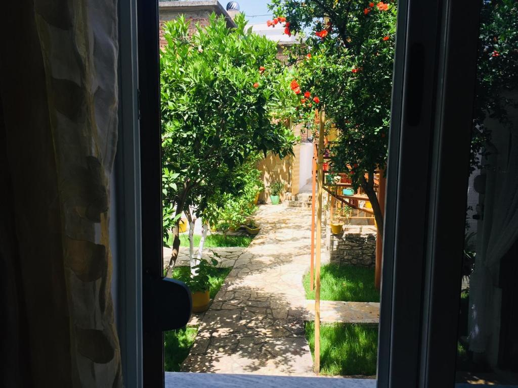 a view from a window of a street with trees at Jemin Apartment in Berat