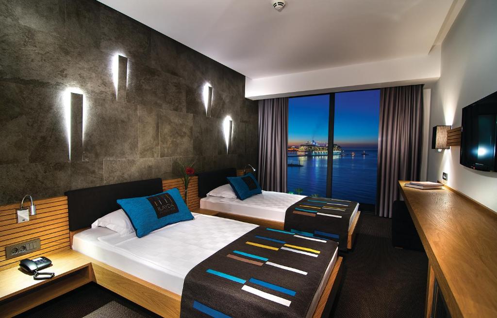 A bed or beds in a room at Ilayda Avantgarde Hotel