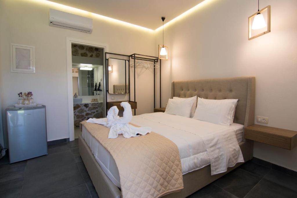 a bedroom with a bed with a white angel on it at Acrothea Perdika in Perdika