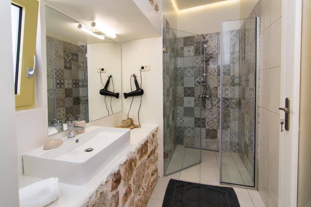 a bathroom with a sink and a shower at Acrothea Perdika in Perdika