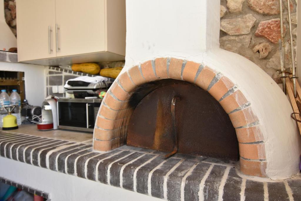 a brick oven on a counter in a kitchen at Acrothea Perdika in Perdika