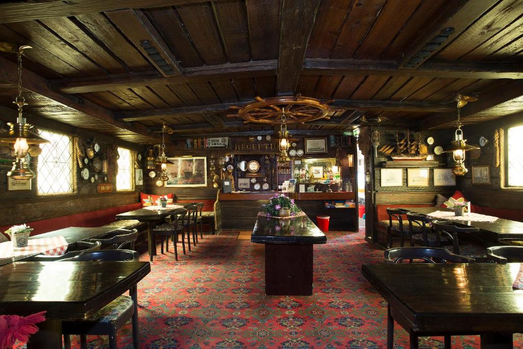 a restaurant with tables and chairs and a bar at Den Röda Båten in Stockholm