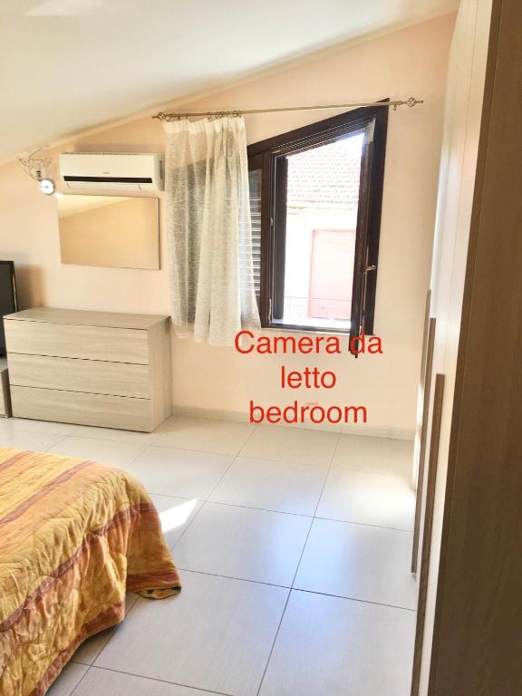 Łóżko lub łóżka w pokoju w obiekcie L'attico di Greta,Etna house