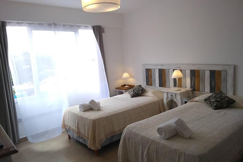Habitación de hotel con 2 camas y ventana en Apart jujuy Suite Premium en San Salvador de Jujuy