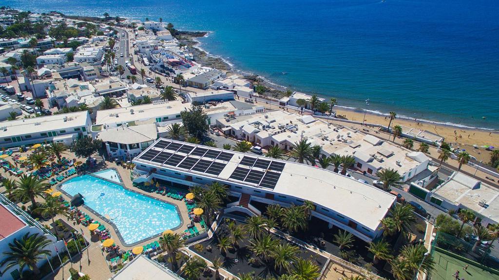 an aerial view of a resort with a swimming pool and a beach at Central location in a great complex with 300mbps internet in Puerto del Carmen