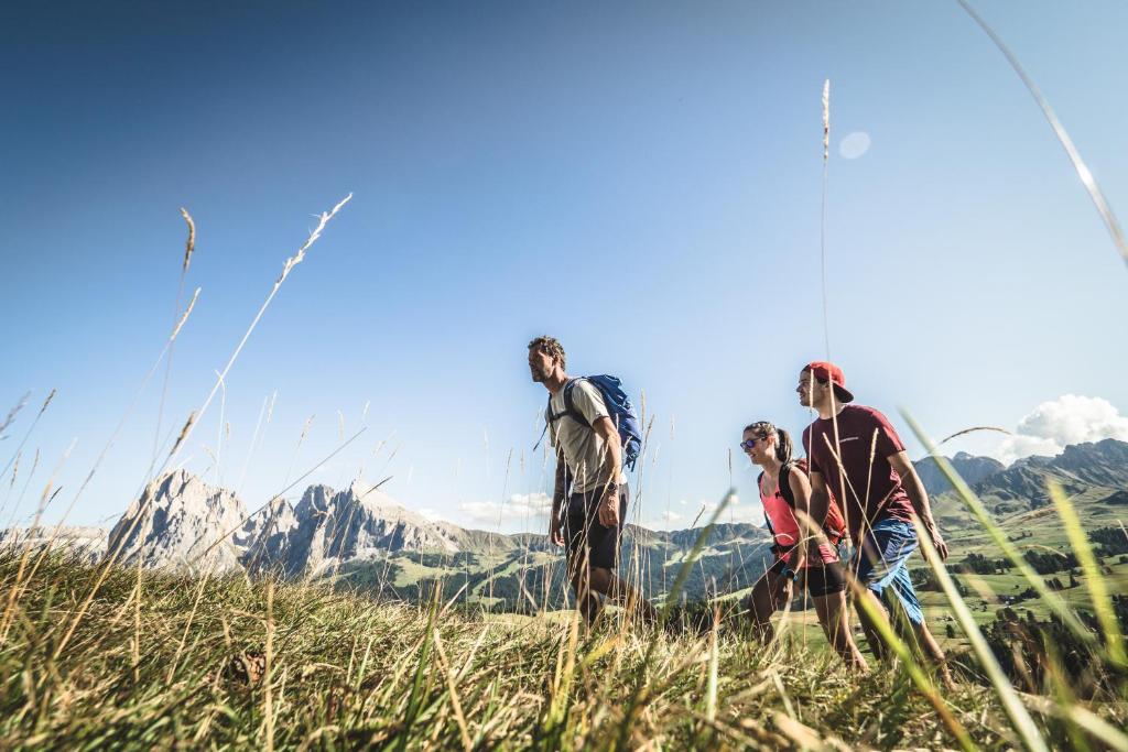 a group of people standing on top of a mountain at Adler Spa Resort Dolomiti in Ortisei