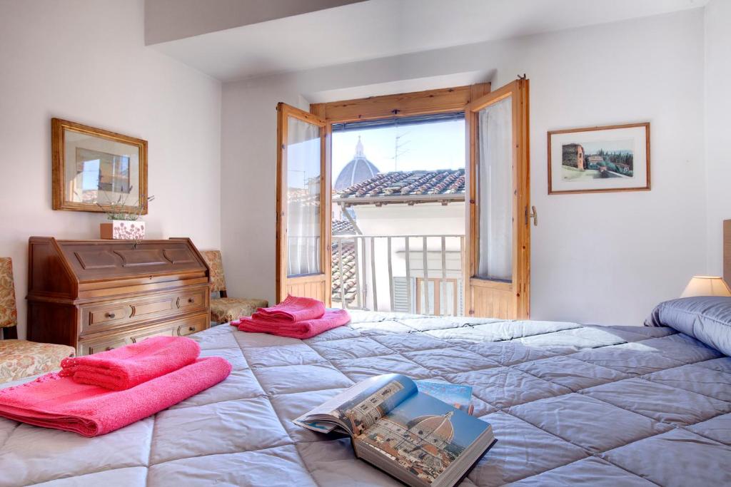a bedroom with a large bed and a window at Appartamento Alfanihouse in Florence