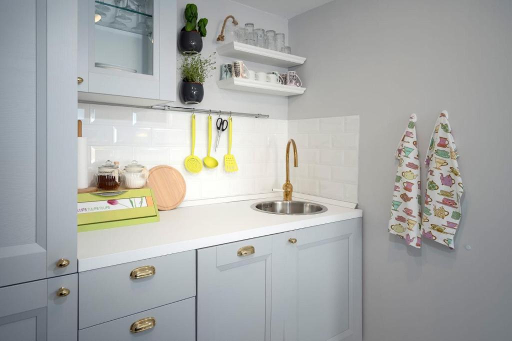 a kitchen with white cabinets and a sink at Holiday Home Belina in Stari Grad