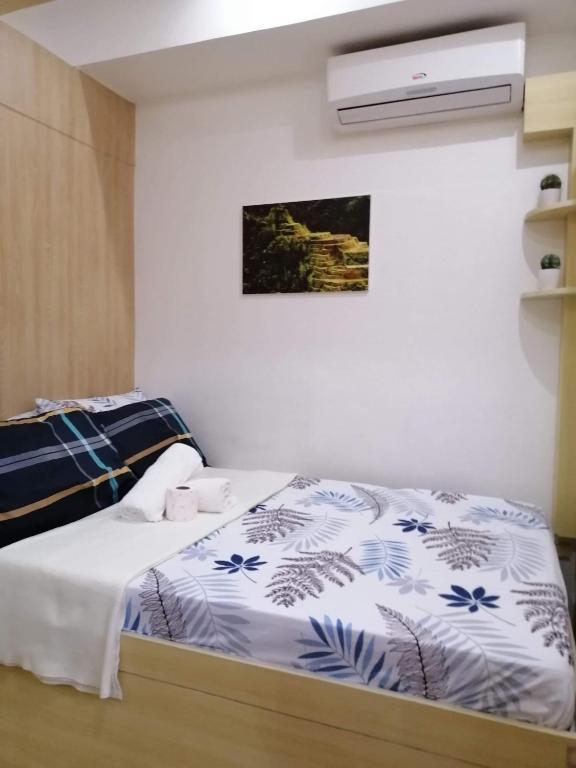 Postel nebo postele na pokoji v ubytování SMDC GRACE RESIDENCIES