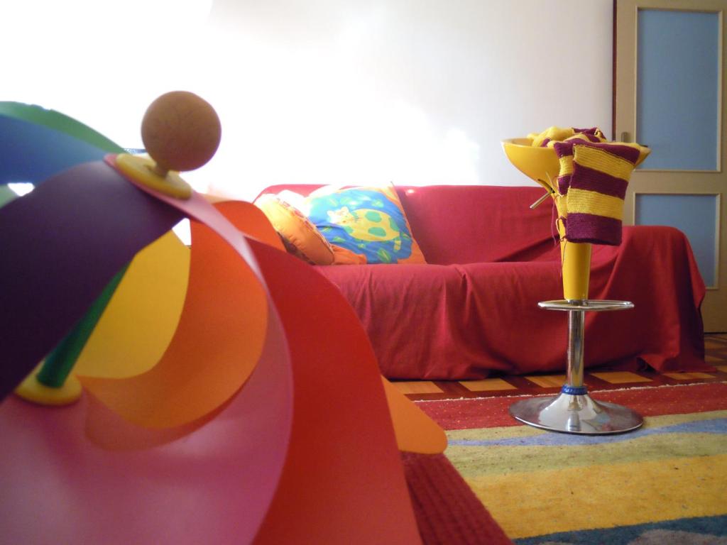 a living room with a couch and a vase at Miss Tortellino in Bologna