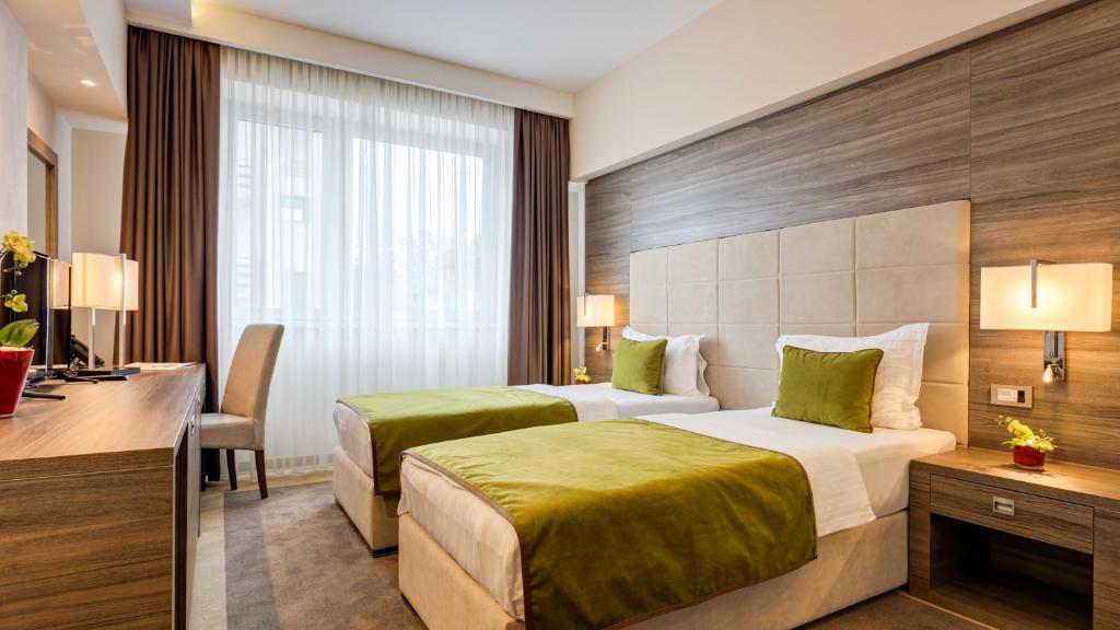 Uma cama ou camas num quarto em Hotel Tami Residence