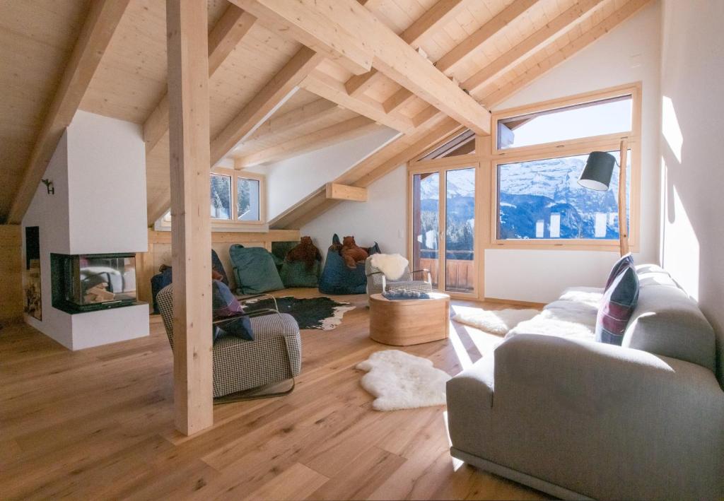 a living room with couches and a fireplace at Chalet Ledibach in Wengen