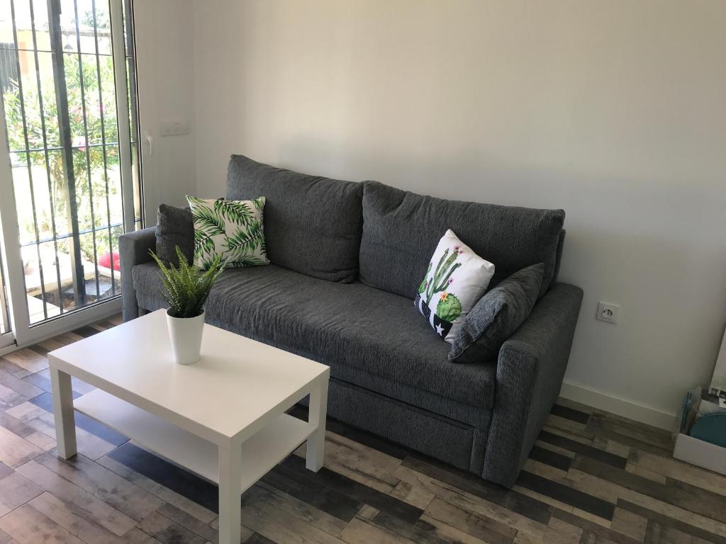 a living room with a couch and a table at La Casita de Laura in Bolonia