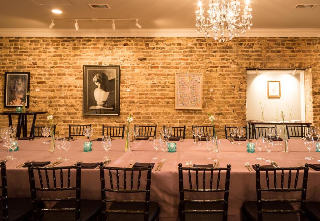 a table set up for a wedding reception in a brick wall at The Vendue, Downtown Art Hotel in Charleston