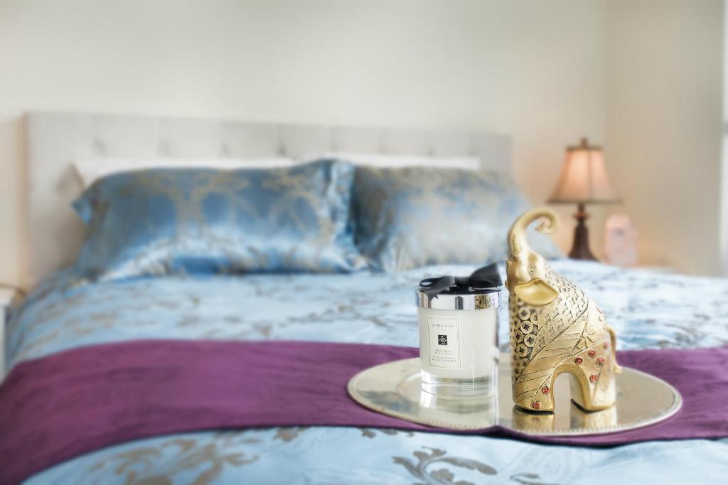 a tray with a candle on a bed at Le Canter in Vancouver