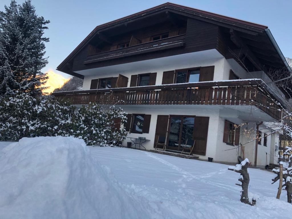 a house in the snow with a pile of snow at Haus JoLoMo in Mallnitz