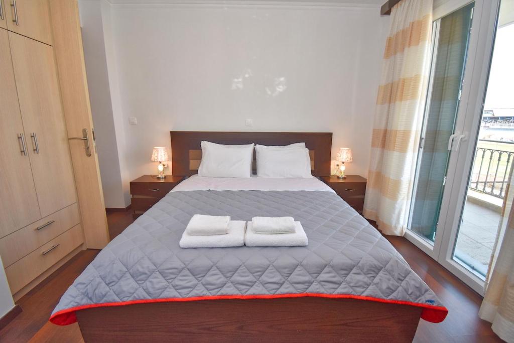 a bedroom with a bed with two towels on it at Windmill Apartment in Corfu