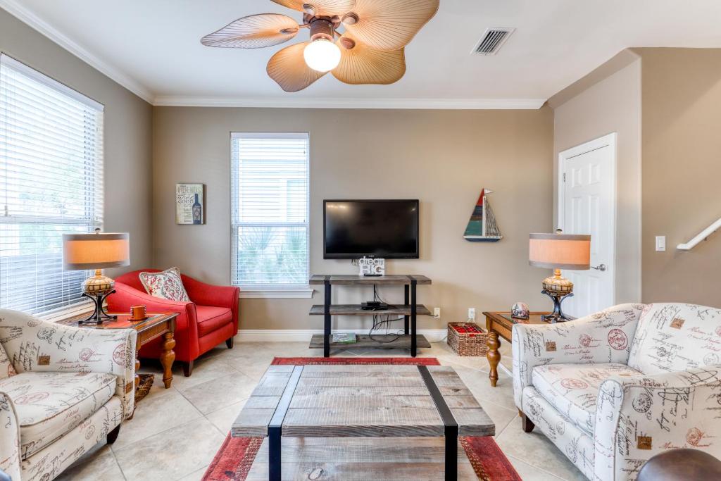 a living room with two couches and a tv at Villages of Crystal Beach: Serenity in Destin