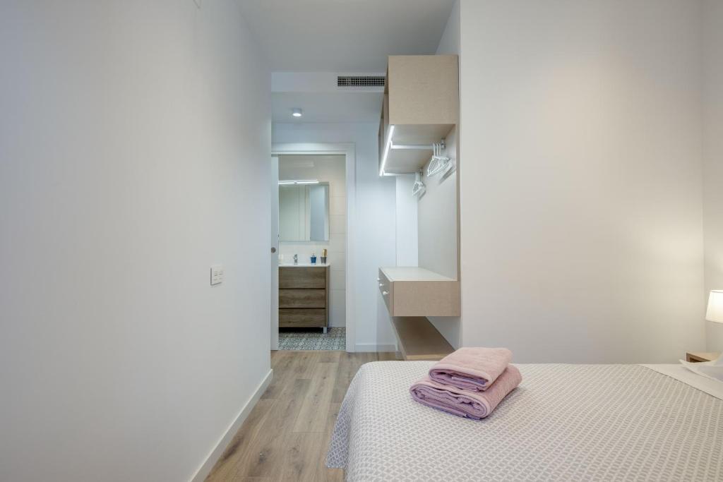 Postel nebo postele na pokoji v ubytování LucasLand Apartments Barcelona