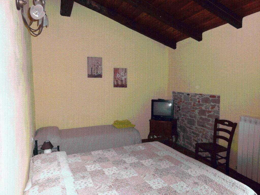 A bed or beds in a room at La Locanda Dei Cartunè