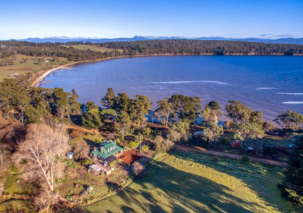an aerial view of a house next to a lake at Ventnor Guest House in South Bruny
