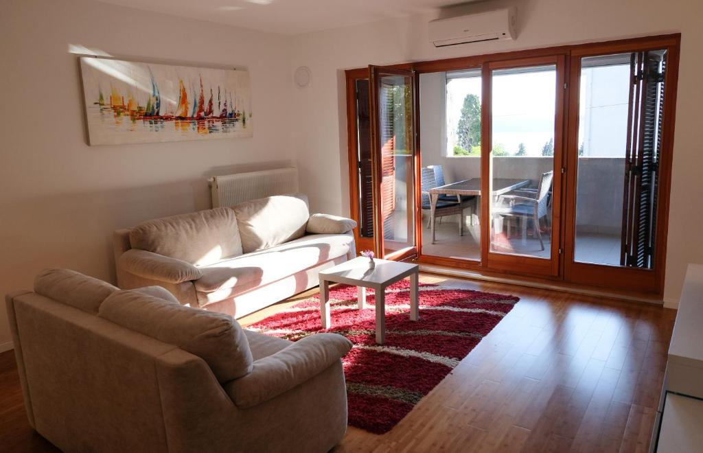 a living room with a couch and chairs and a table at Apartment Summertime in Crikvenica