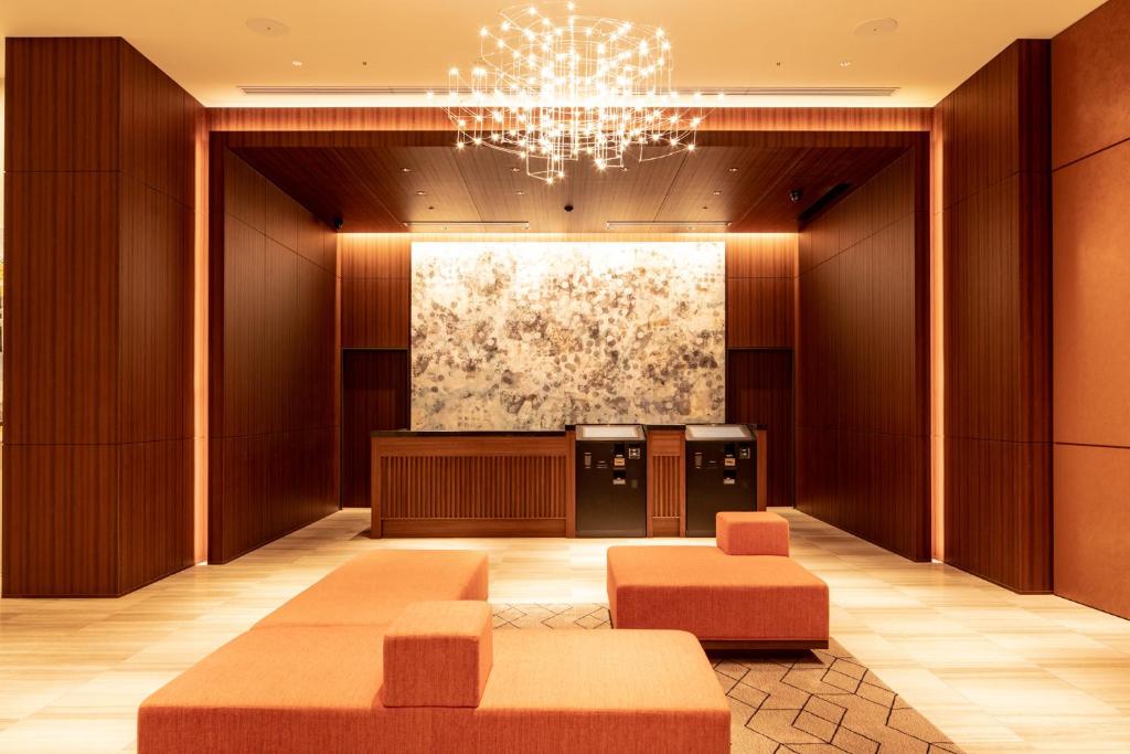 a lobby of a hotel with a chandelier at HOTEL FORZA HAKATAEKI CHIKUSHIGUCHI Ⅱ in Fukuoka