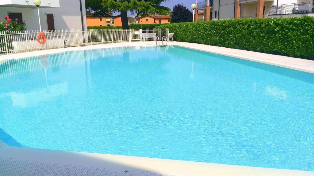 a large blue swimming pool in front of a building at Casa Sant Elena ID15675 in Peschiera del Garda