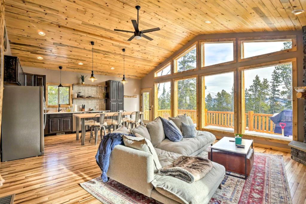 a living room with a couch and a kitchen at Mountainside Fairplay Cabin with Game Room and Sauna! in Fairplay