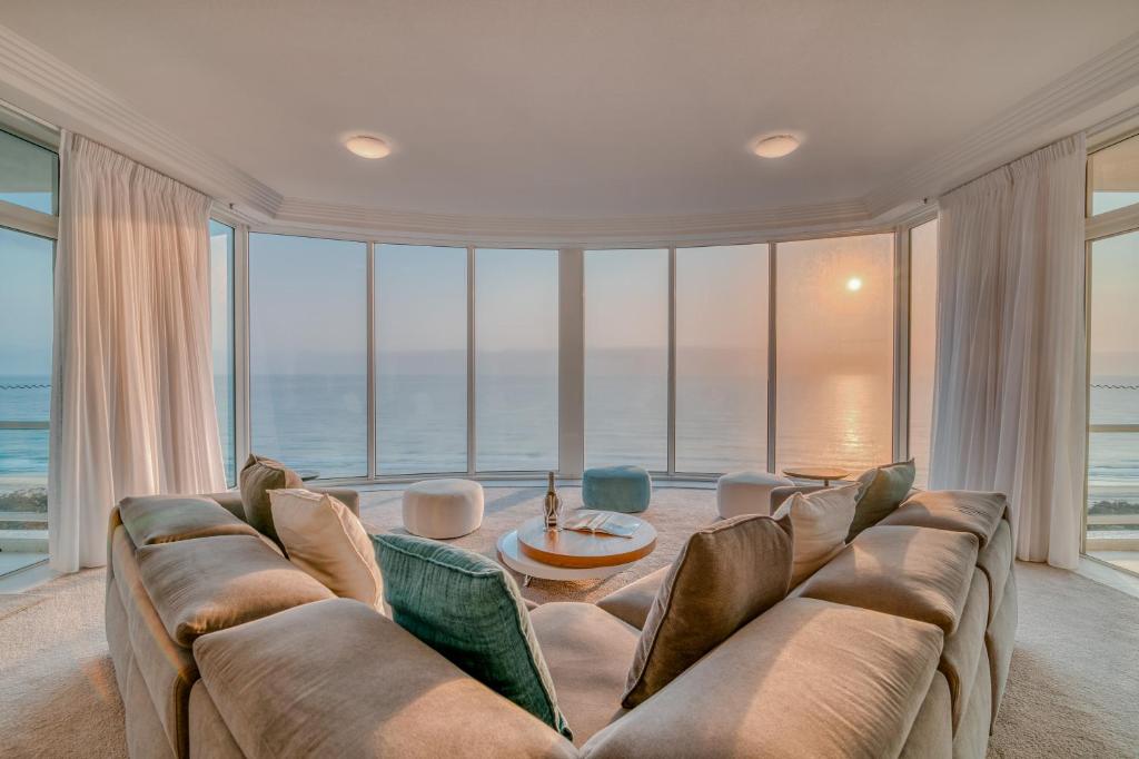 a living room with a couch and a table at Carmel by the Sea in Gold Coast