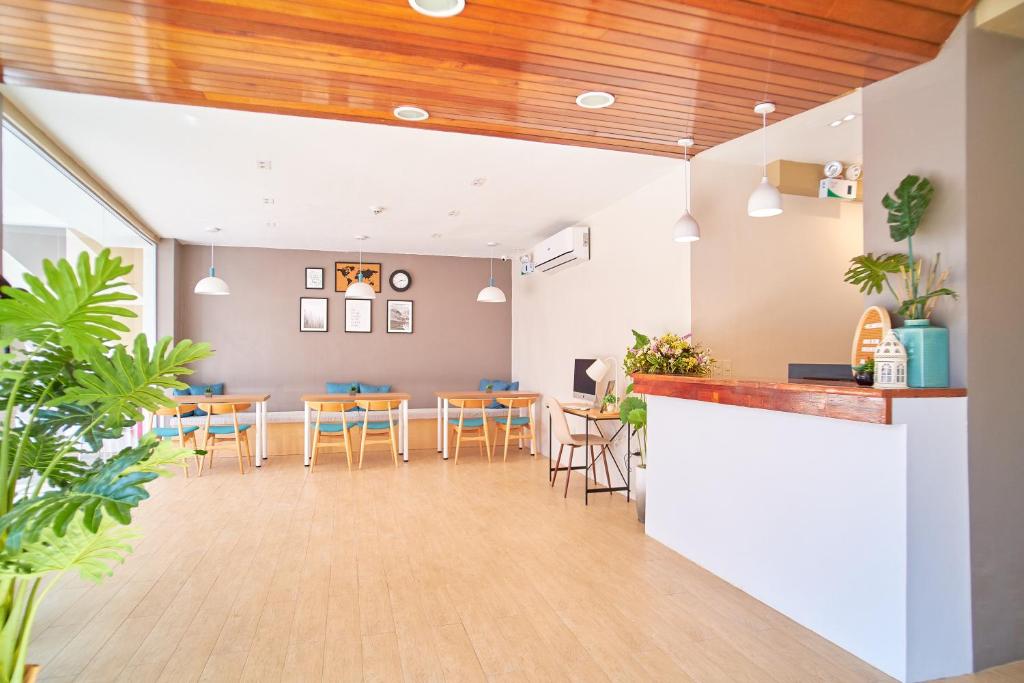 a lobby with tables and chairs and a bar at Bridge Hotel Express in Cagayan de Oro