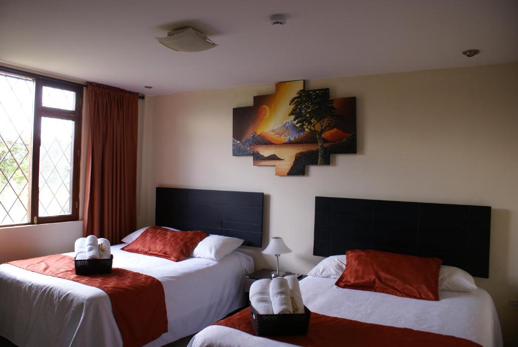 Postel nebo postele na pokoji v ubytování Hotel Las Mercedes Airport-Quito