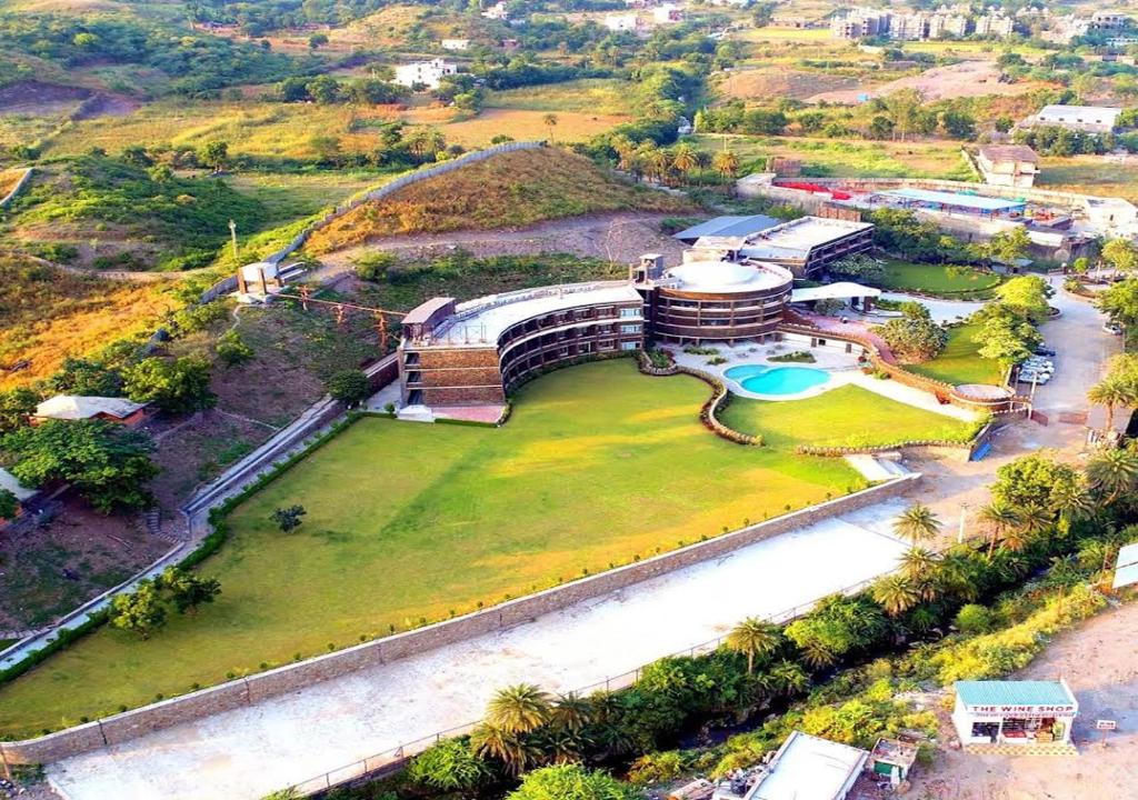 an aerial view of a building on a green field at Seasons Park Resort in Udaipur