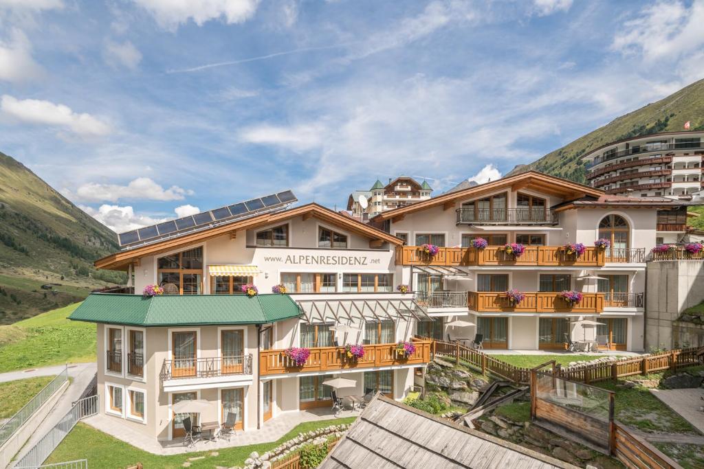 a building with balconies on the side of a mountain at Alpenresidenz am Mühlbach in Obergurgl