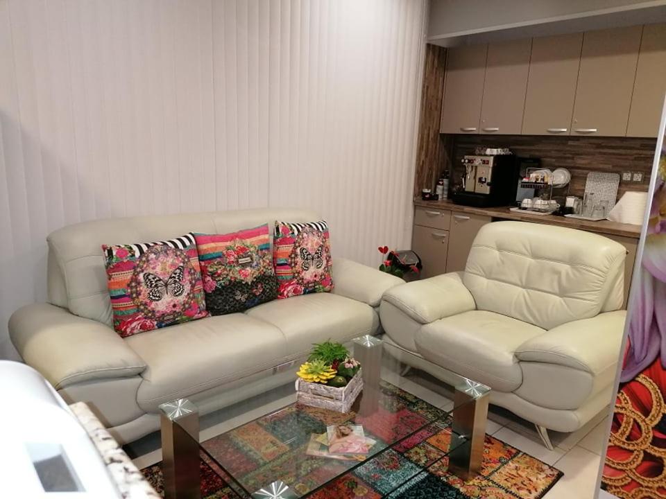 a living room with a couch and two chairs at Astoria in Hisarya