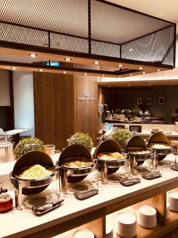 a buffet line with many plates of food on a table at Palmer Hotel in Taichung