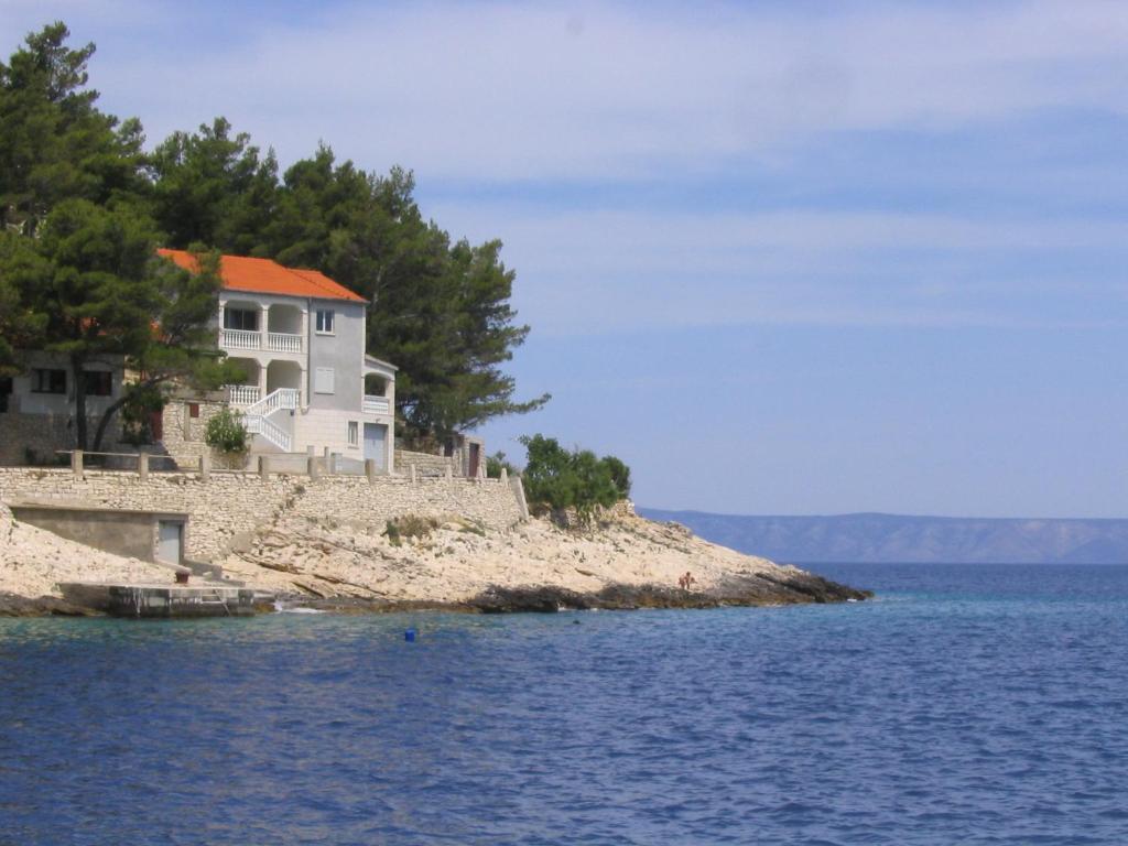 a house on an island in the water at Apartments Gugic in Prigradica
