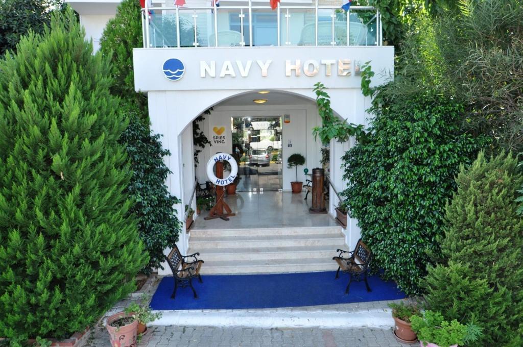 a lobby of a may hotel with stairs and trees at Navy Hotel in Marmaris