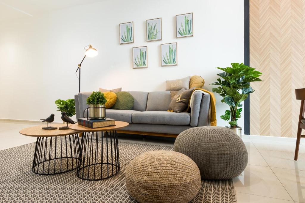 a living room with a couch and a table at EkoCheras Cozy Suite by DreamScape in Kuala Lumpur