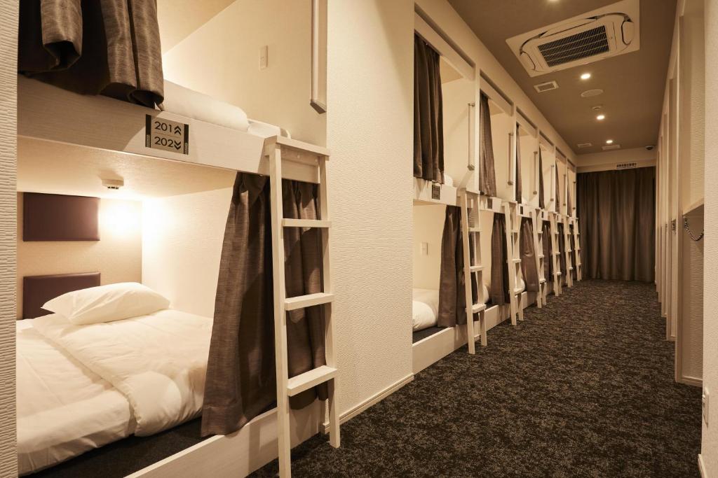 a row of bunk beds in a dorm room at HOTEL THE ROCK in Osaka