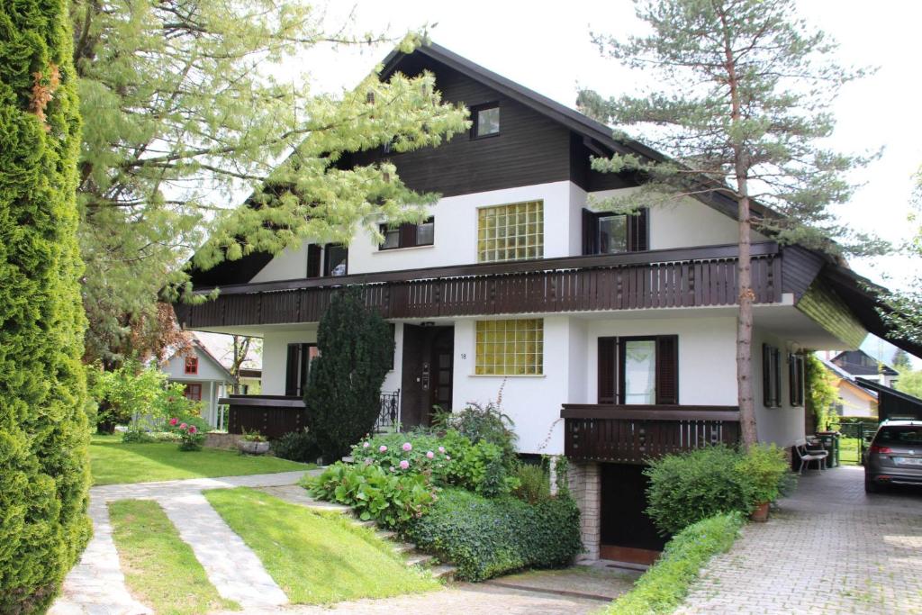a house with a black and white at Apartments Poldi in Bled