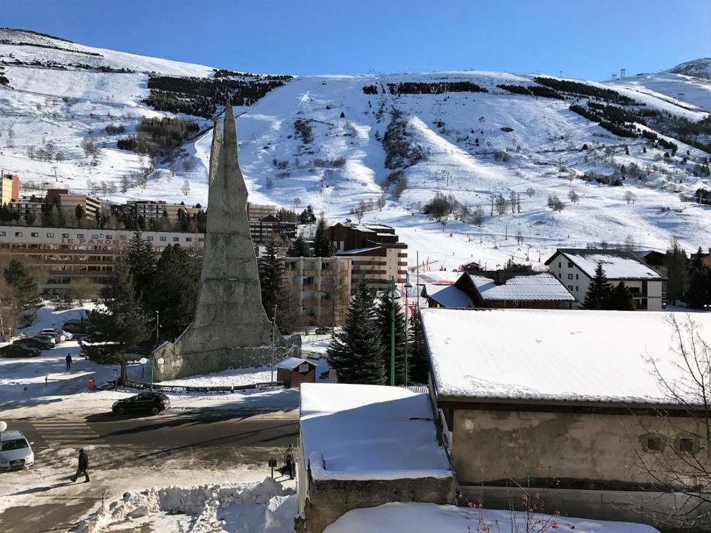 a town in the snow with a church at Boost Your Immo Les Deux Alpes Grande Chaume 173 in Les Deux Alpes